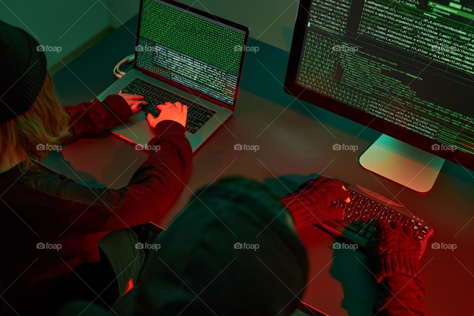 Anonymous people using computer and programming to break code. Cyber security threat. Internet and network security. Access to private information. Anonymous hackers using technology to access to password and encrypted data. Cyber attack