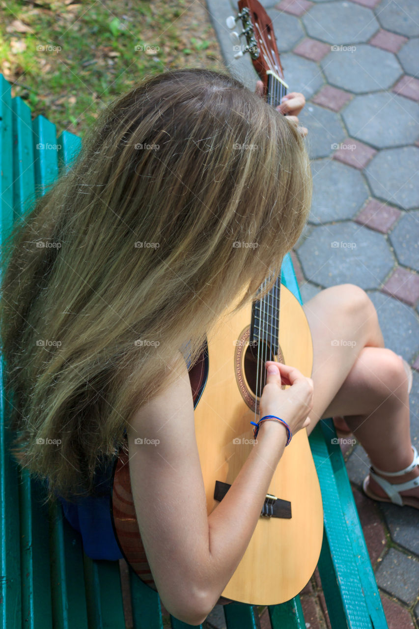 girl playing the guitar