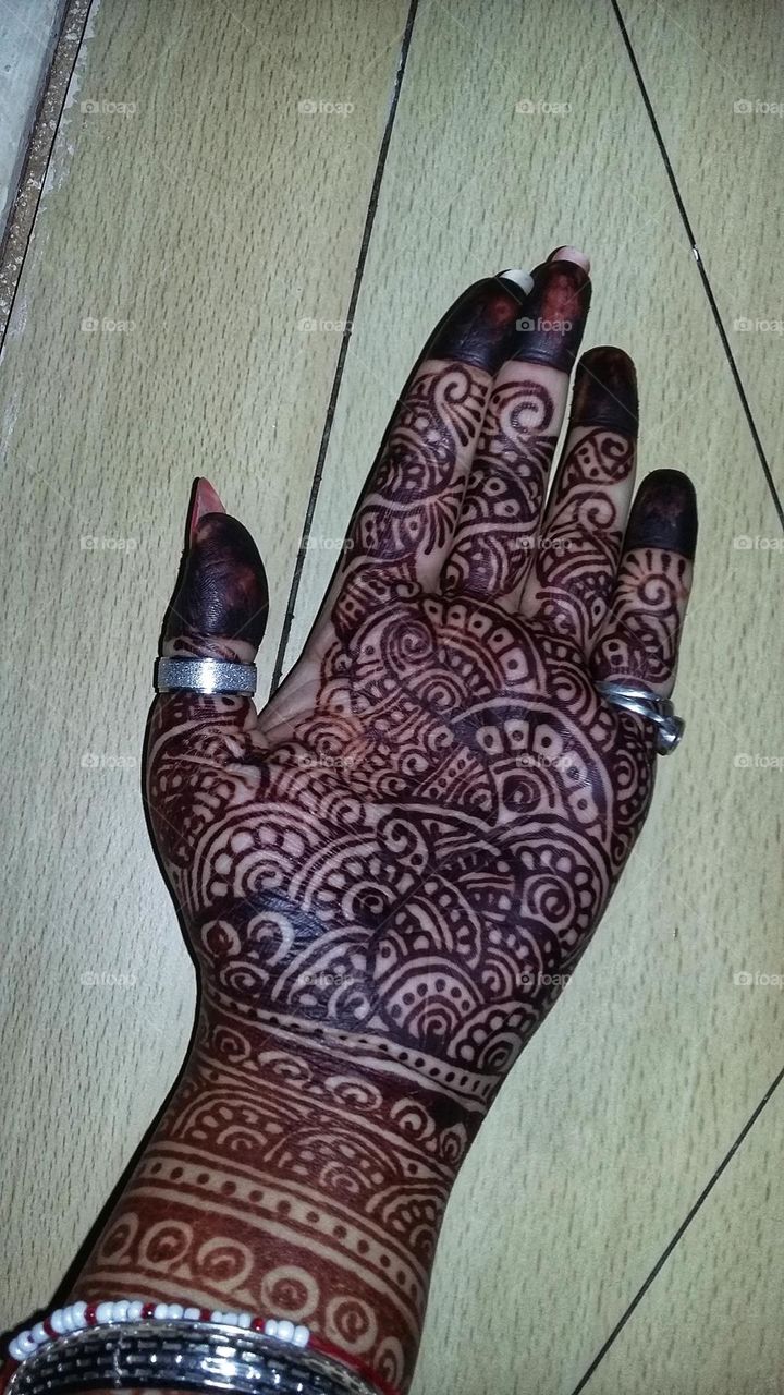 beautiful mehandi art on palm.