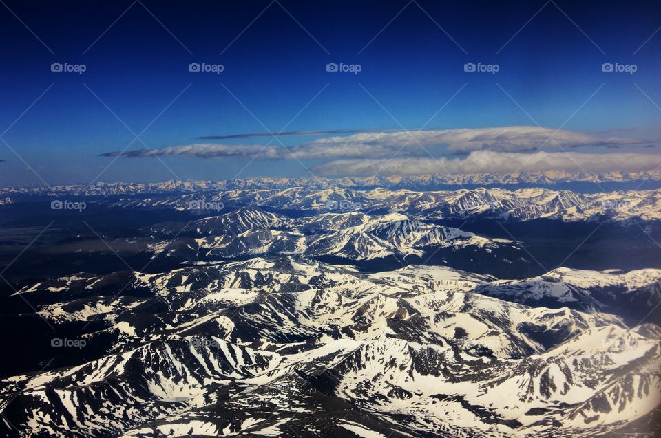 Flying over the snow capped Rocky Mountains in Denver Colorado 