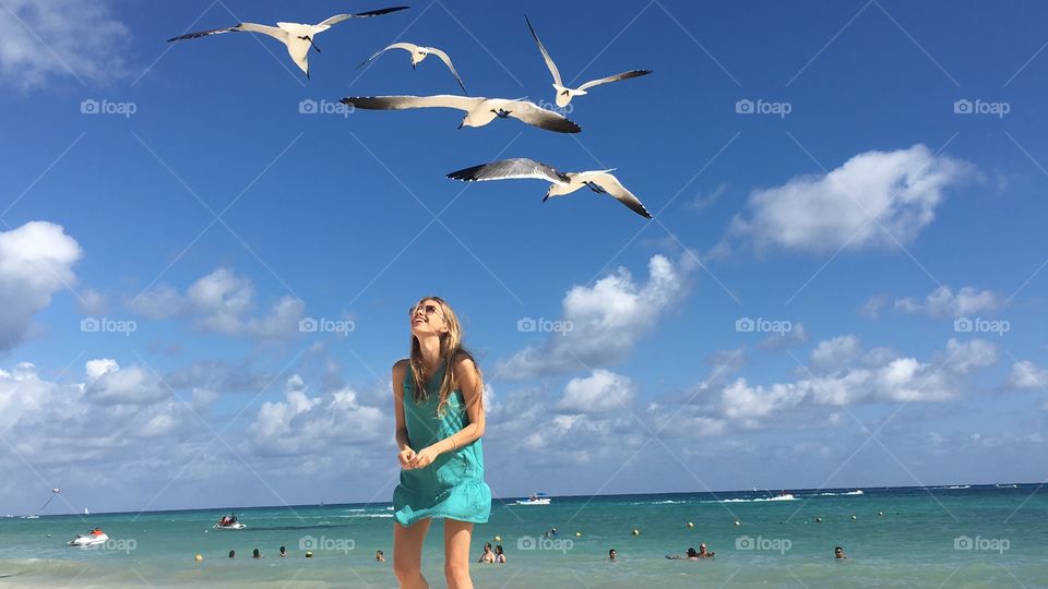 Seagulls fly above me in Playa del Carmen, Yucatan peninsula. Girl and birds. Katya laughs and seagulls 