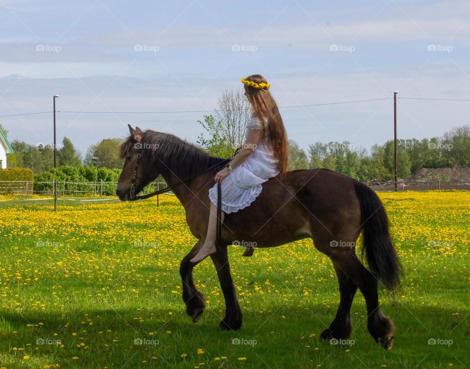 beautiful woman at her horse into spring flowers field. I feel the smell from here ,it feels like . ❤️🧡💛