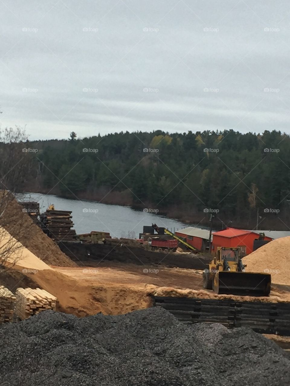 Looking at Lahaie Lumber from the hillside you can see the logs and mill down at the water and Mountains sawdust 