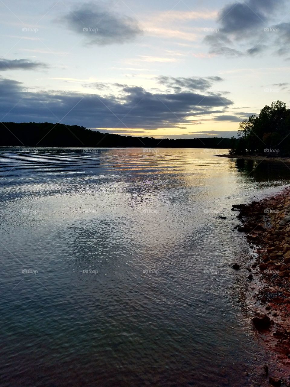 sunset over lake with ripples.