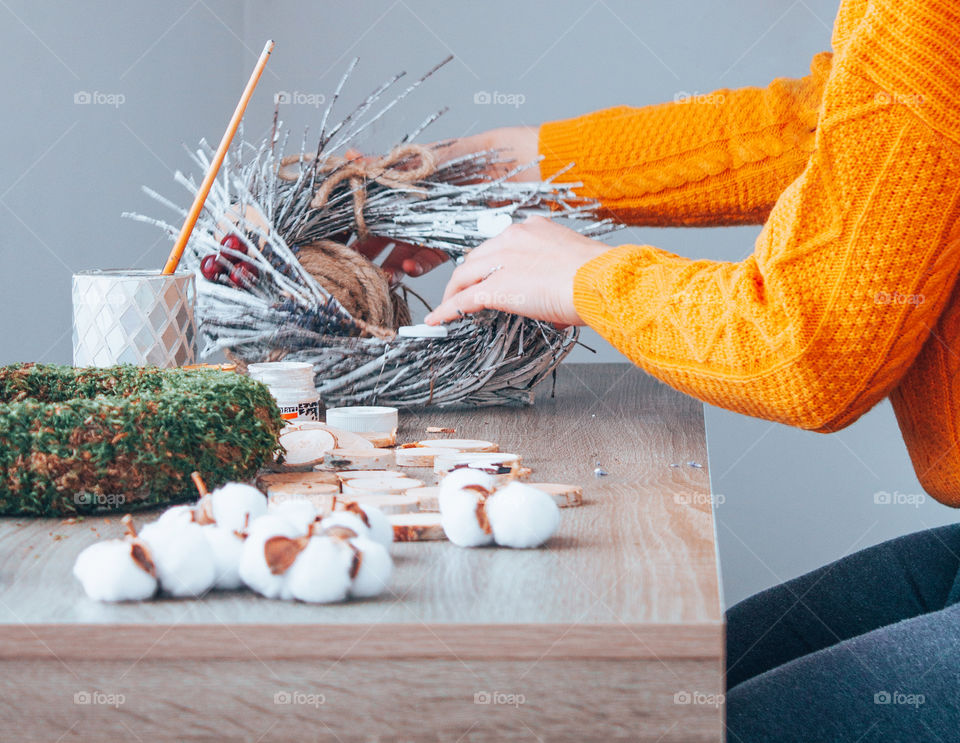 photo of a woman crafting an Easter wreath made only from eco friendly materials