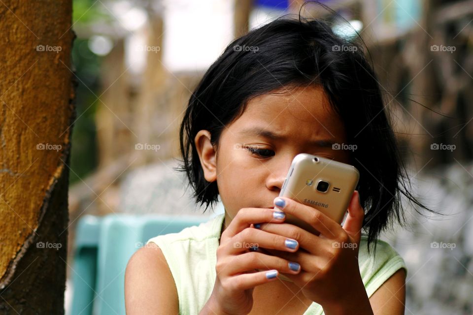 young girl watching a video on a smartphone