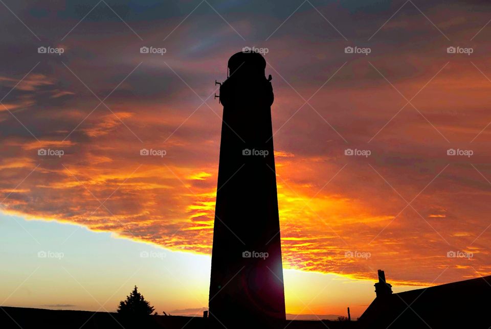 Lighthouse shilloutte at sunset. nature, sky, beautiful, outdoor, background, sunset, landscape, light, summer, travel, plant, color, beauty, orange, sun, sunrise, bright, view, season, tree, spring, morning, dawn, blue, natural, evening, sunlight