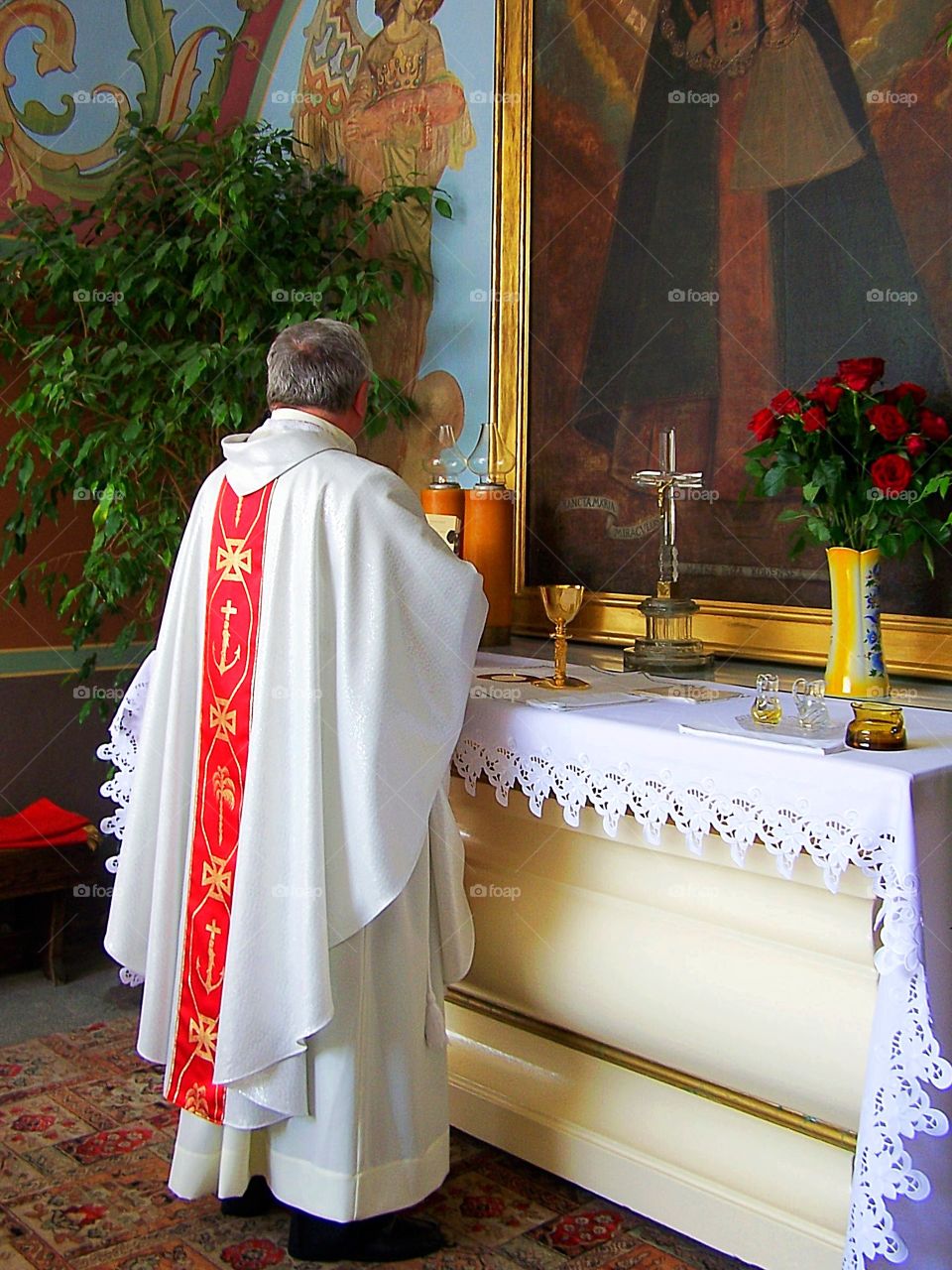 My students attending a ceremony at Jasna Gora Monastery in Częstochowa, Poland, and here watch a priest prepare before the Black Madonna. 