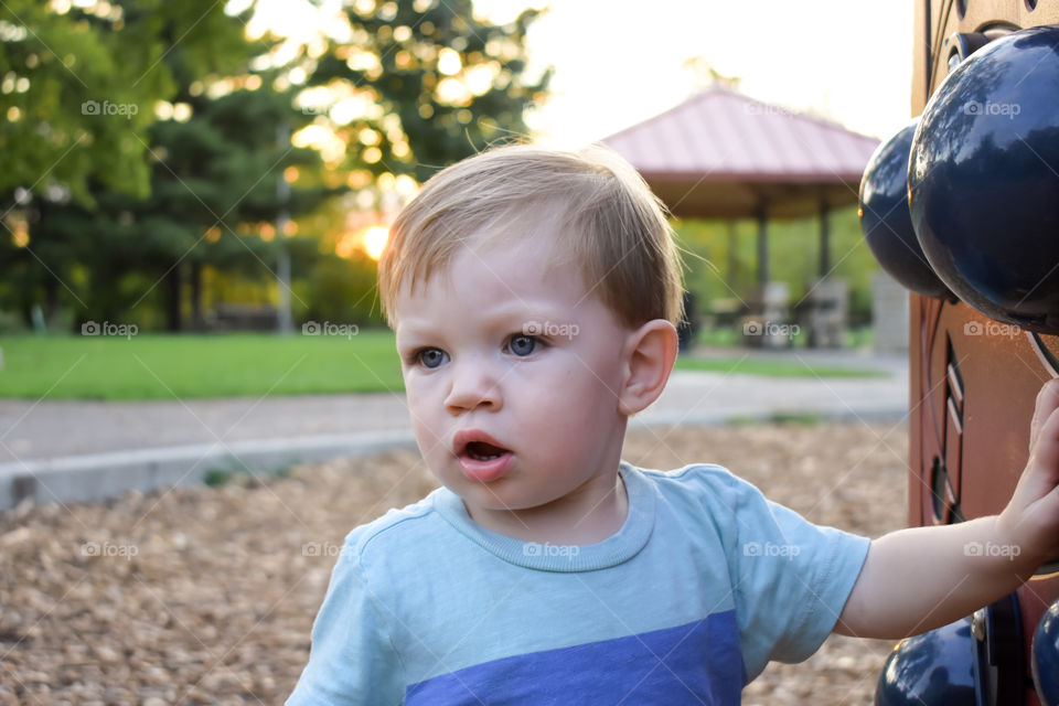 Cute curious toddler on playground 