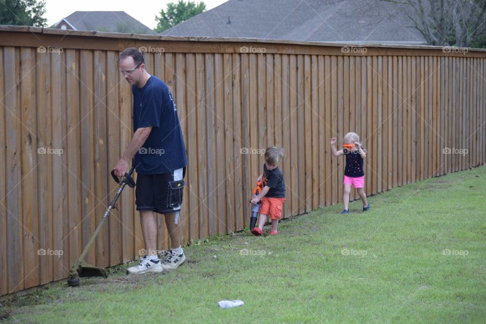 Son and daughter helping dad