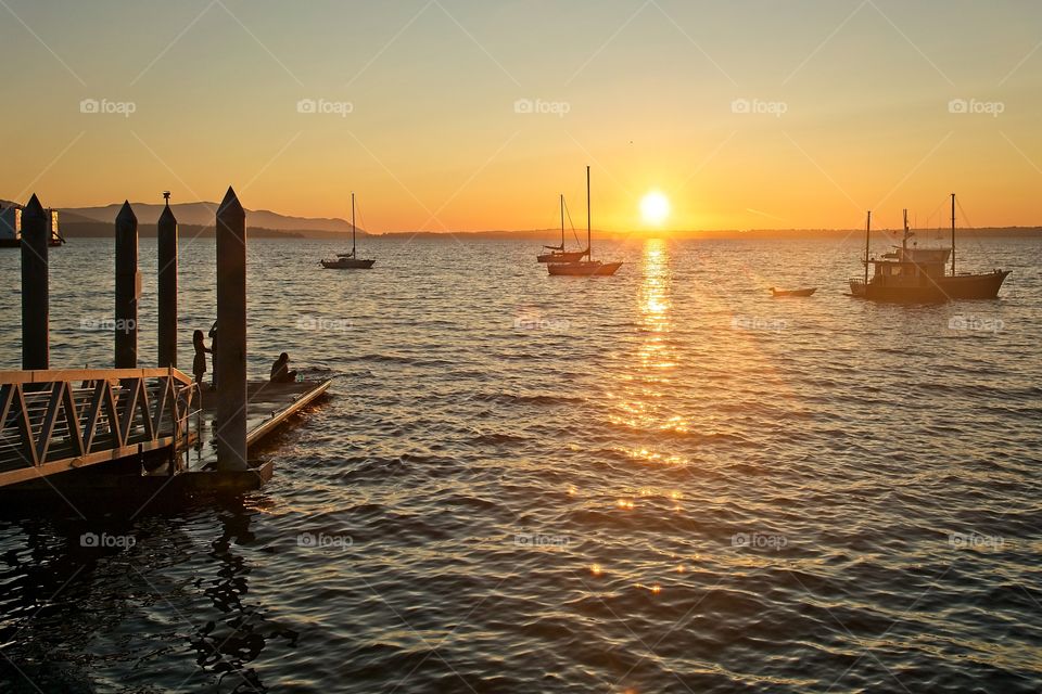 Silhouetted harbor during sunset