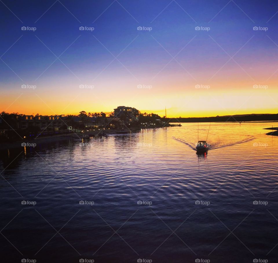 Purple sunset boat on the water 