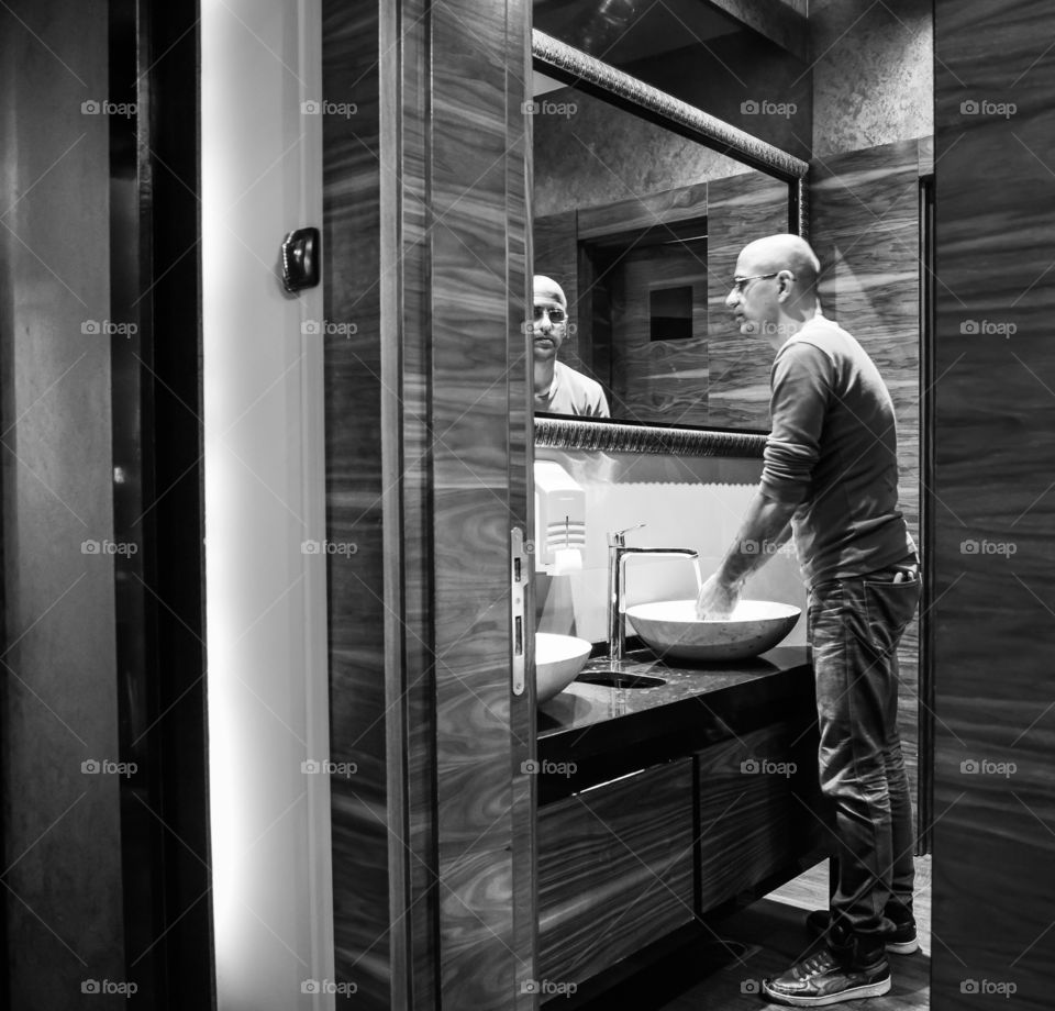 man washing hands in restaurant