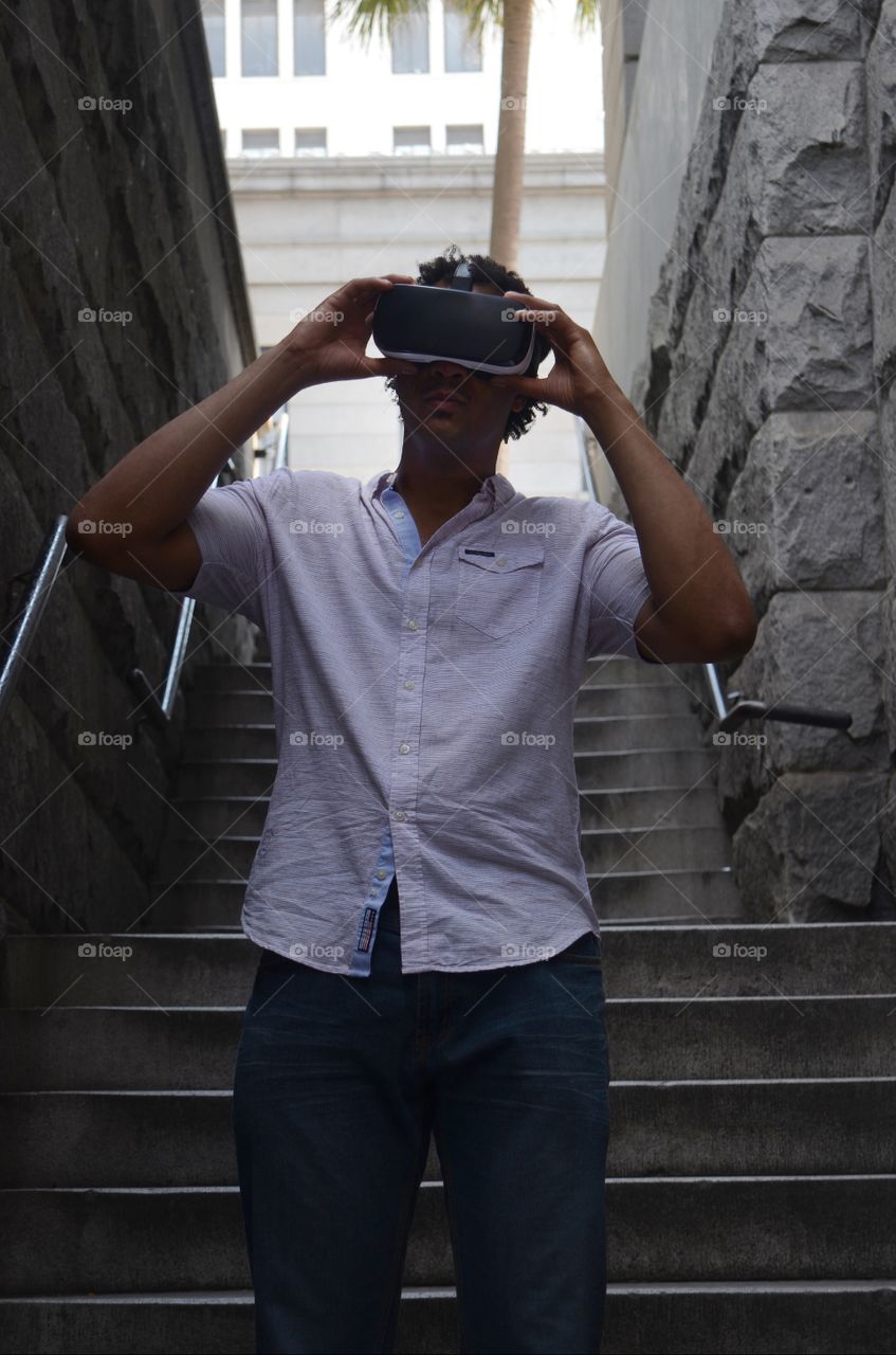 A young man hacks into a virtual world while waiting in a stairwell in the historic downtown Savannah.