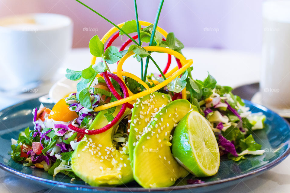 Delicious fresh and healthy salad on table with drinks. Beautifully decorated lunch that looks amazing