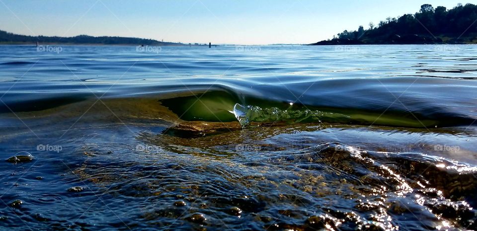 Clear wave breaking on a rock