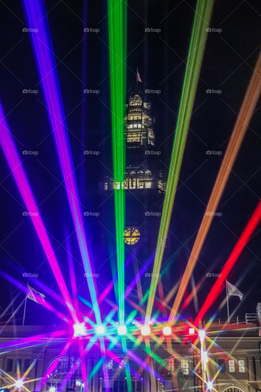 San Francisco Pride 2023 laser light display of the pride flag colors illuminating the sky in front of the Ferry Building on the Embarcadero