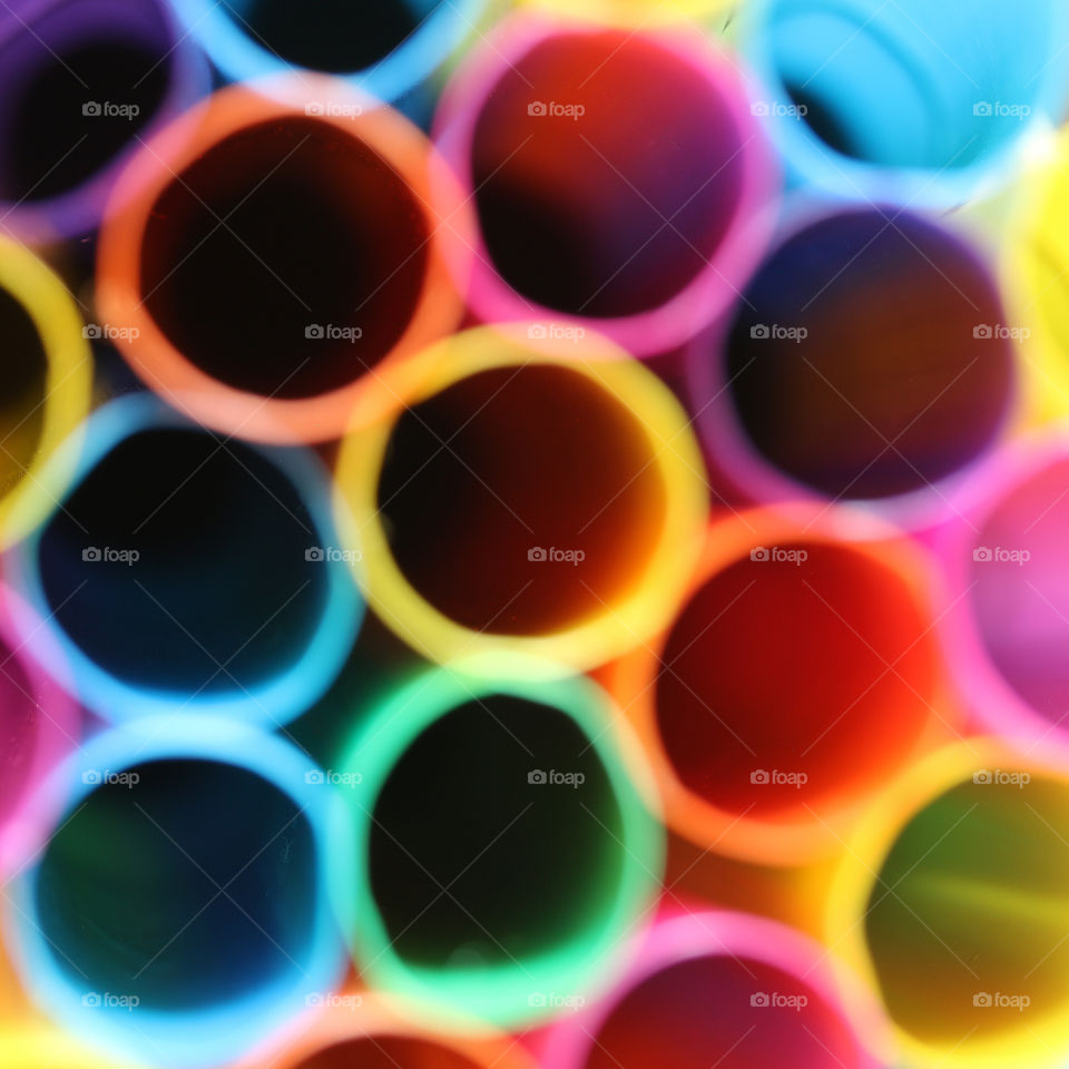 Abstract and out of focus plastic straws in a variety of colors
