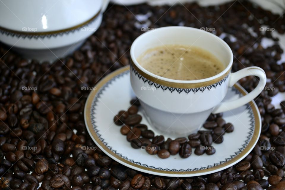 Cup of coffee with coffee beans