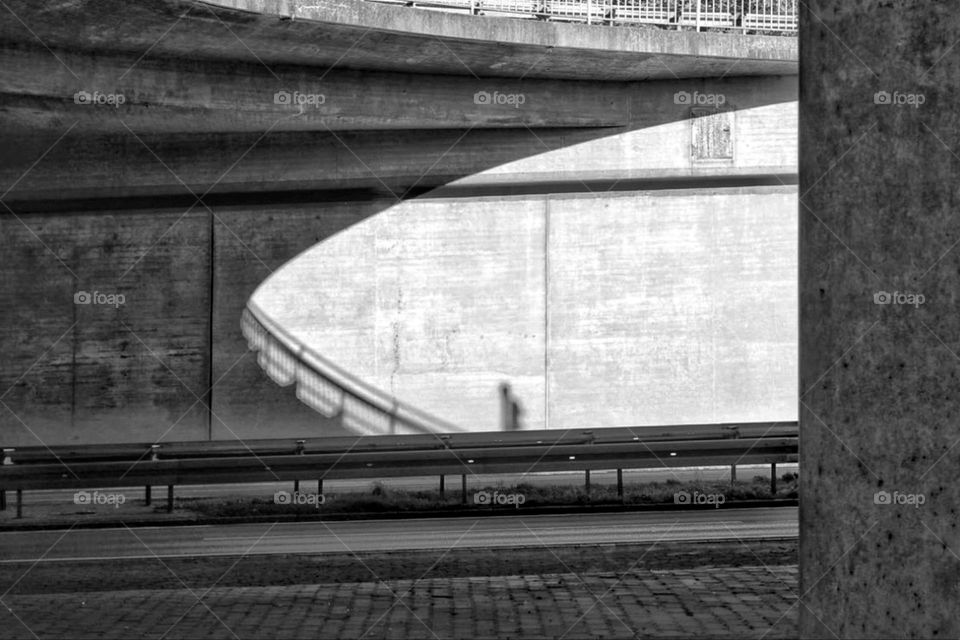 Black and white photo of the architecture under a highway bridge