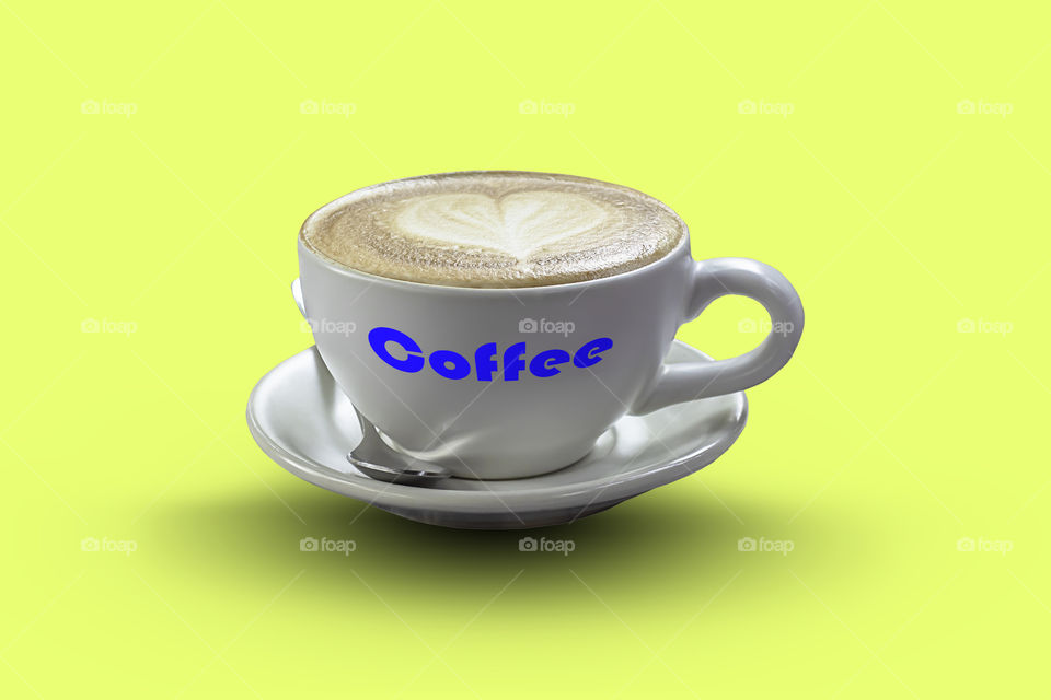 Hot coffee Espresso topped with a heart-shaped milk in white glass on a yellow background with clipping path.