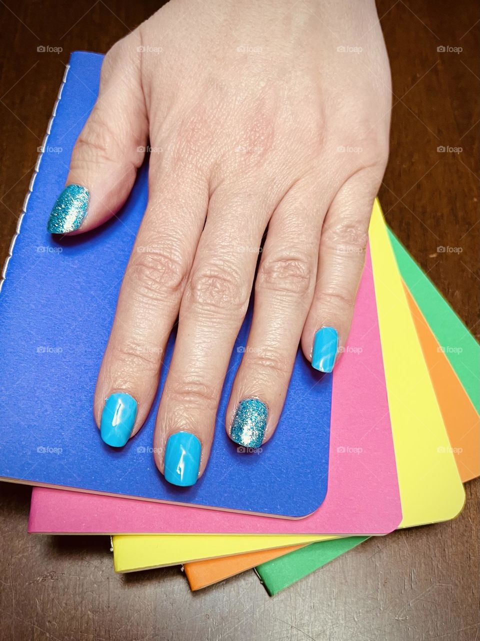 Pretty bright blue sparkly gel nail polish manicure 