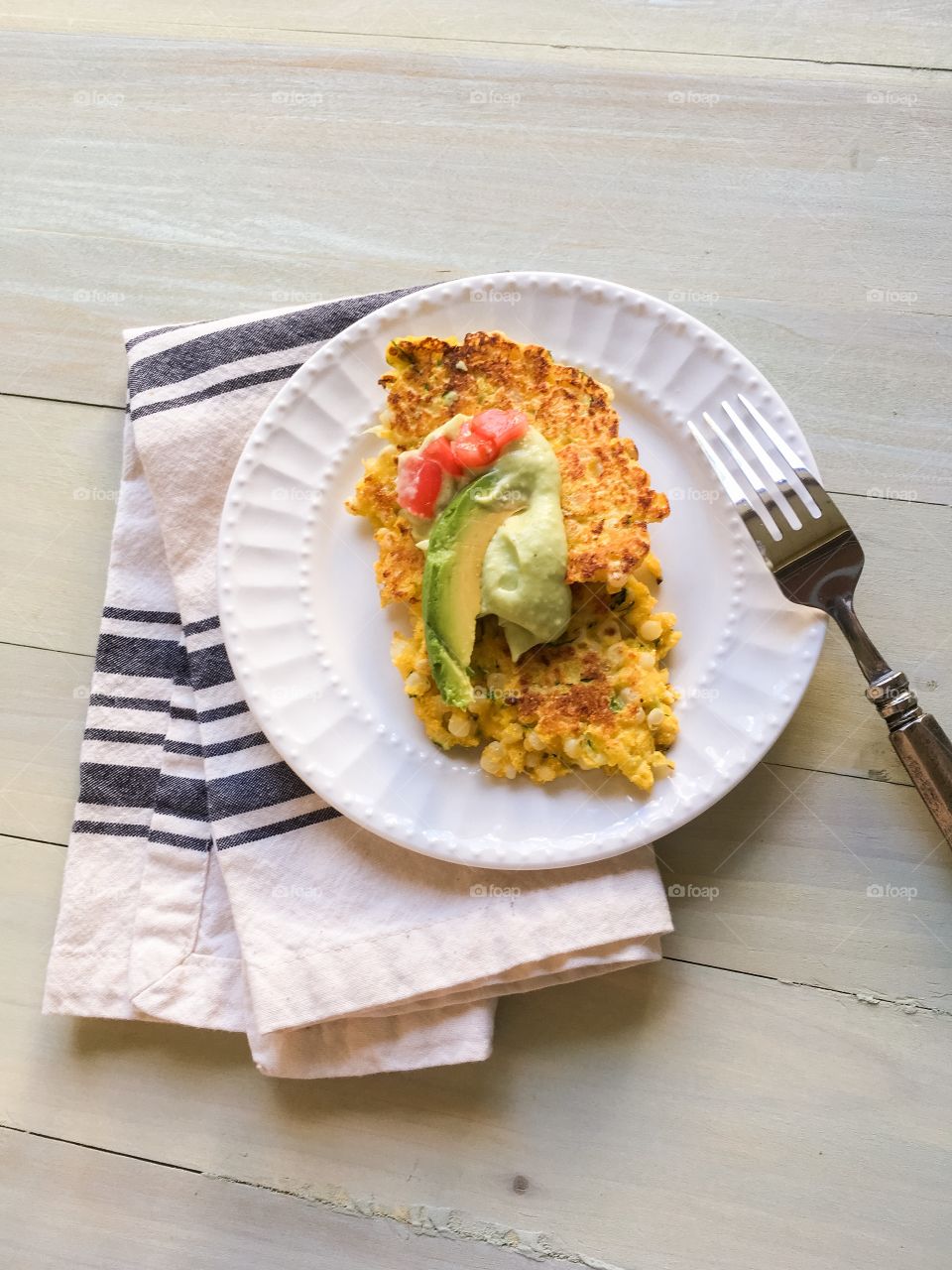 Zucchini and corn fritters with avocado crema 