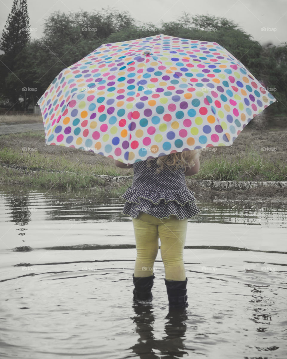 Toddler playing in the rain