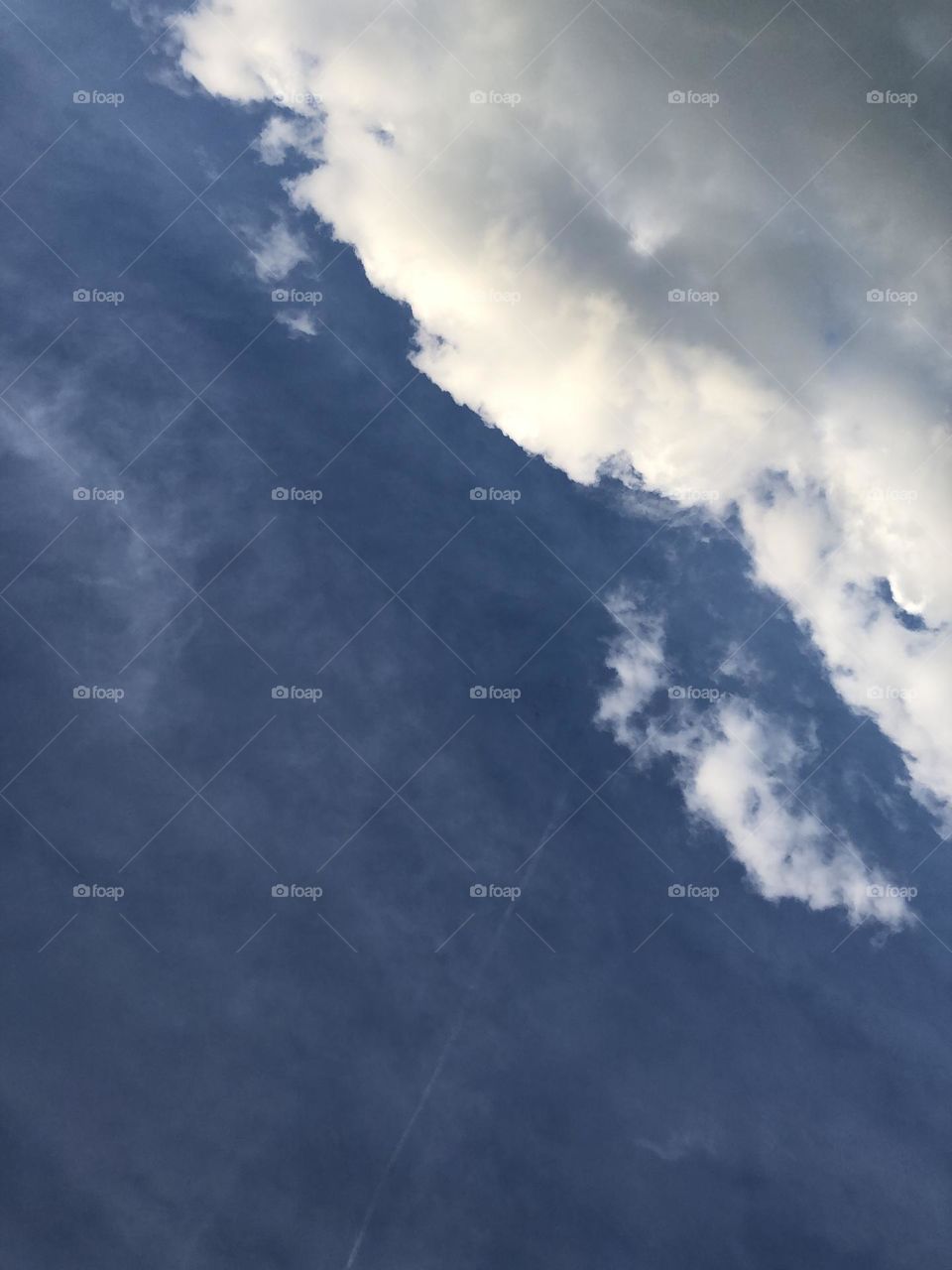 Fluffy white clouds in a brilliant blue sky. 