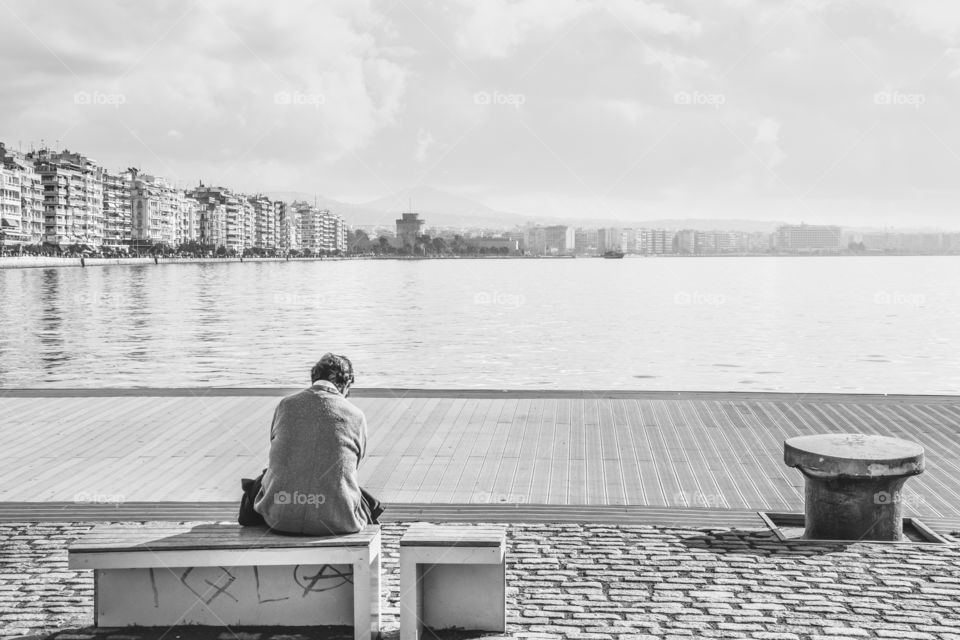 Man Sitting Alone At The Dock And Enjoying The View
