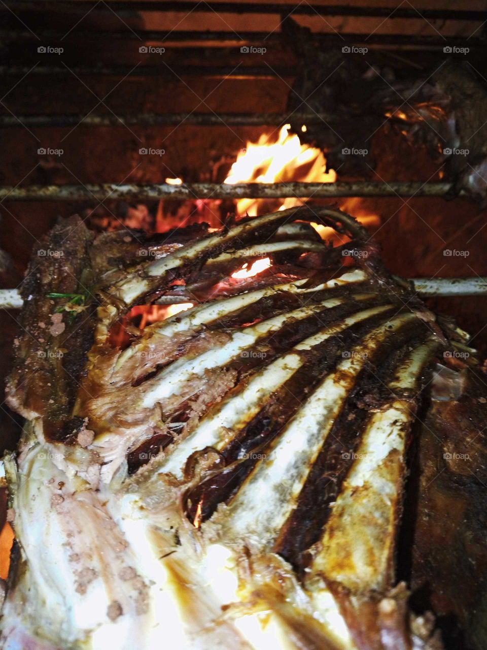 Picture of a Lamb rib in a barbecue grill, in Brazil. Delicious meat with barbecue sauce.