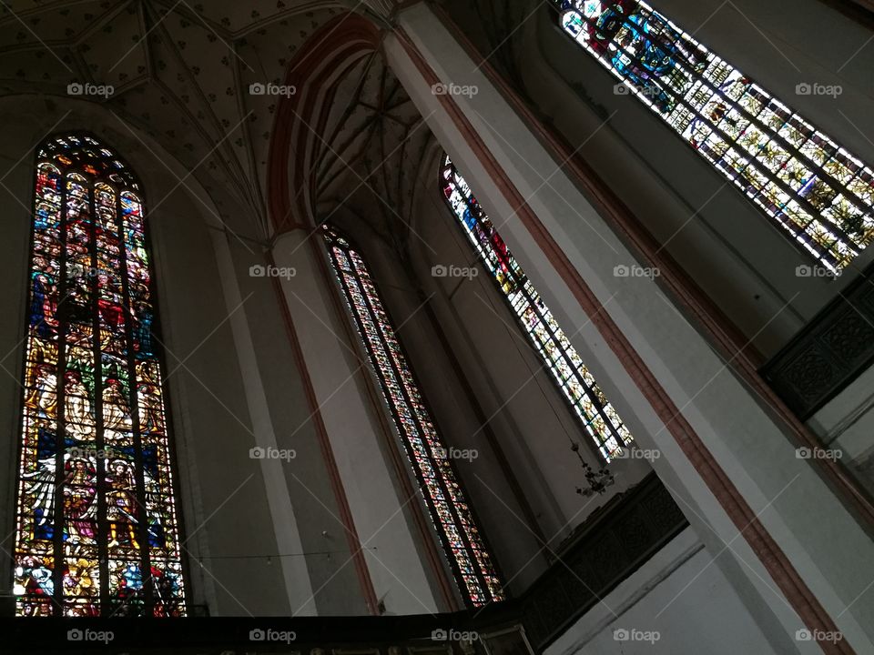 Inside the church with beautiful arches and stained glass windows 