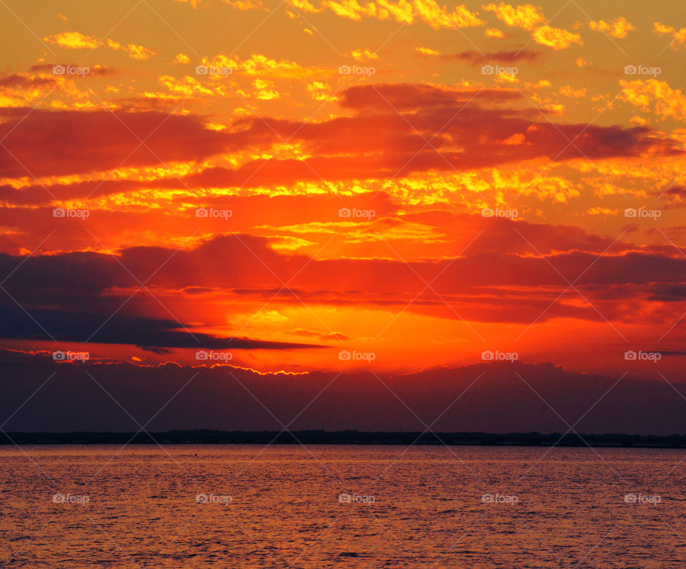 Scenic view of sea against dramatic sky