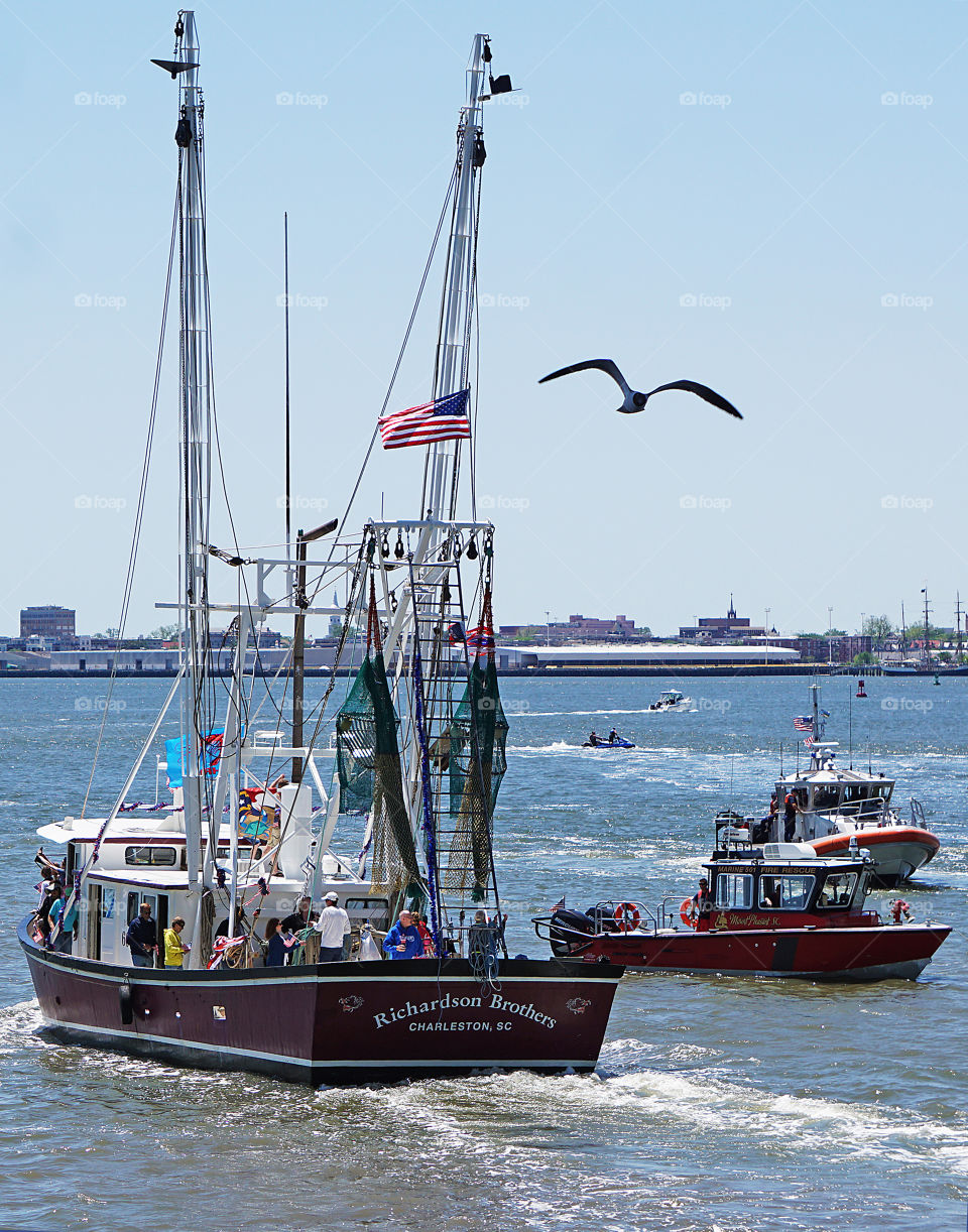 Shrimp boat, motor boats and seagull