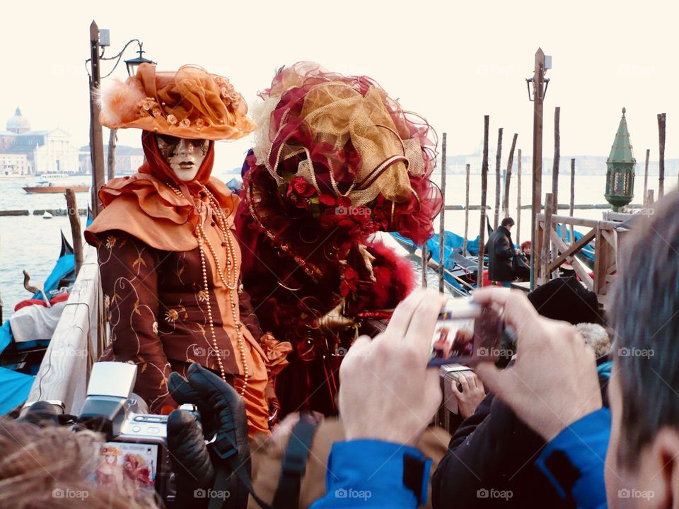 Venetian masks costume parading in St Mark square in Venice 