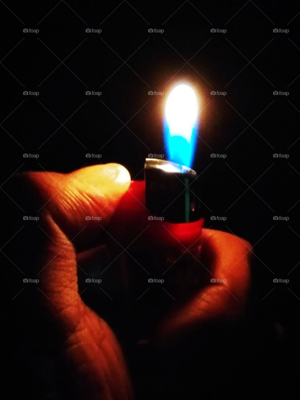 A click of a flame of a lighter .....in dark....