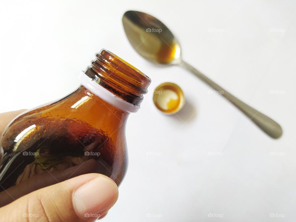 Finished pouring liquid cough medicine into a tablespoon