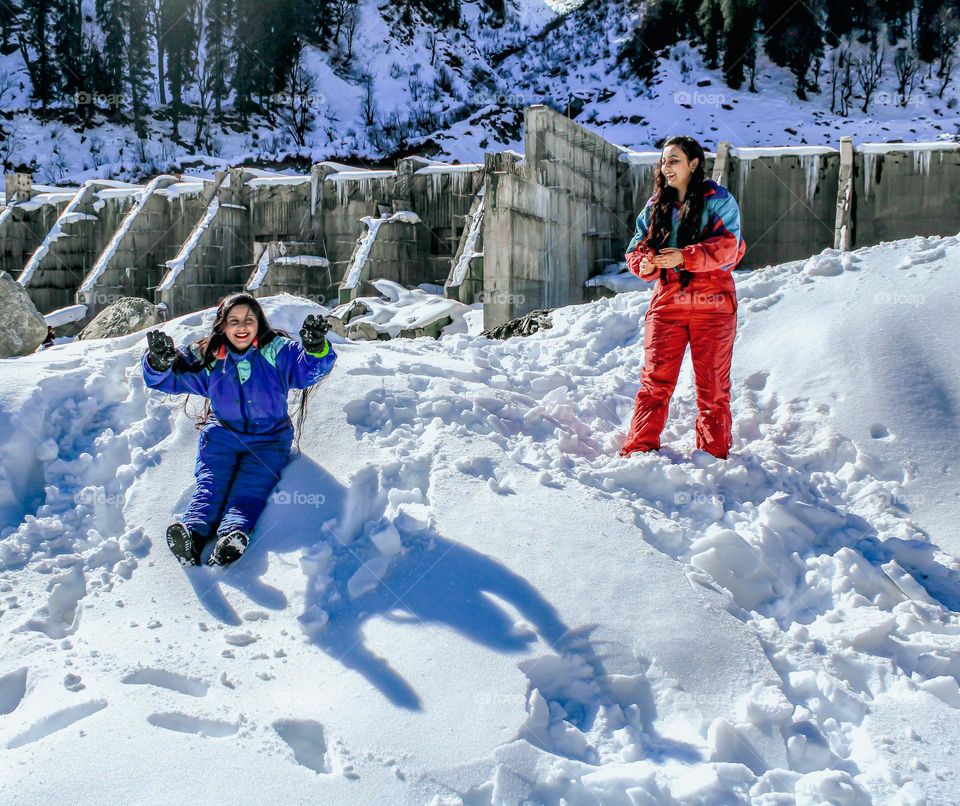 Female friends playing with snow