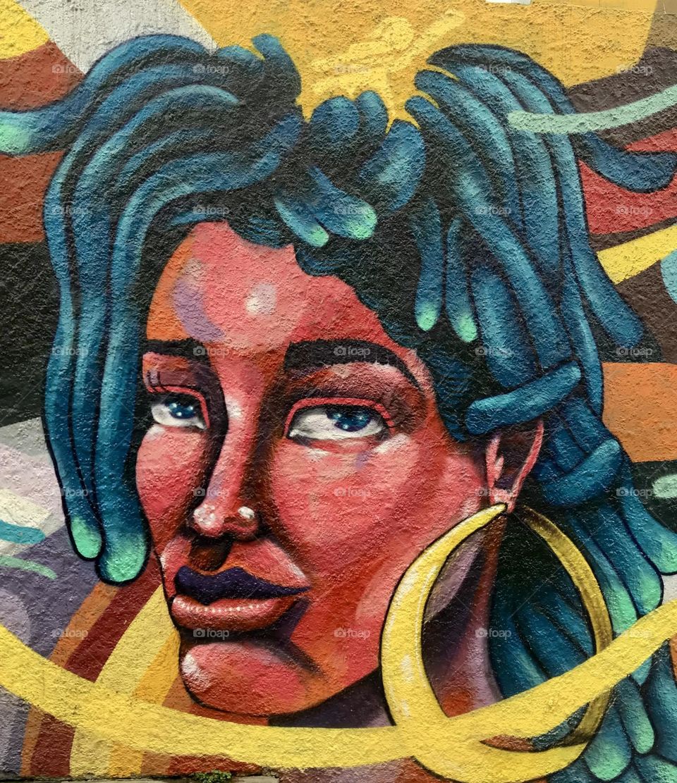 Mural of blue haired woman, colorful street art in Lima, Peru