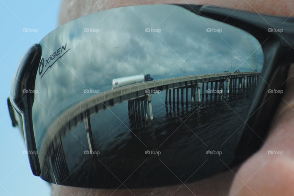 Reflection of a great view. Bridge with beautiful background reflected in sunglasses