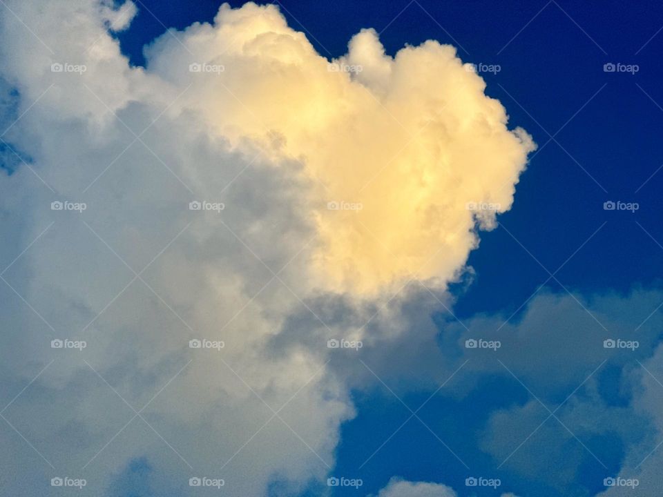 Golden cloudscape in a deep blue sky.