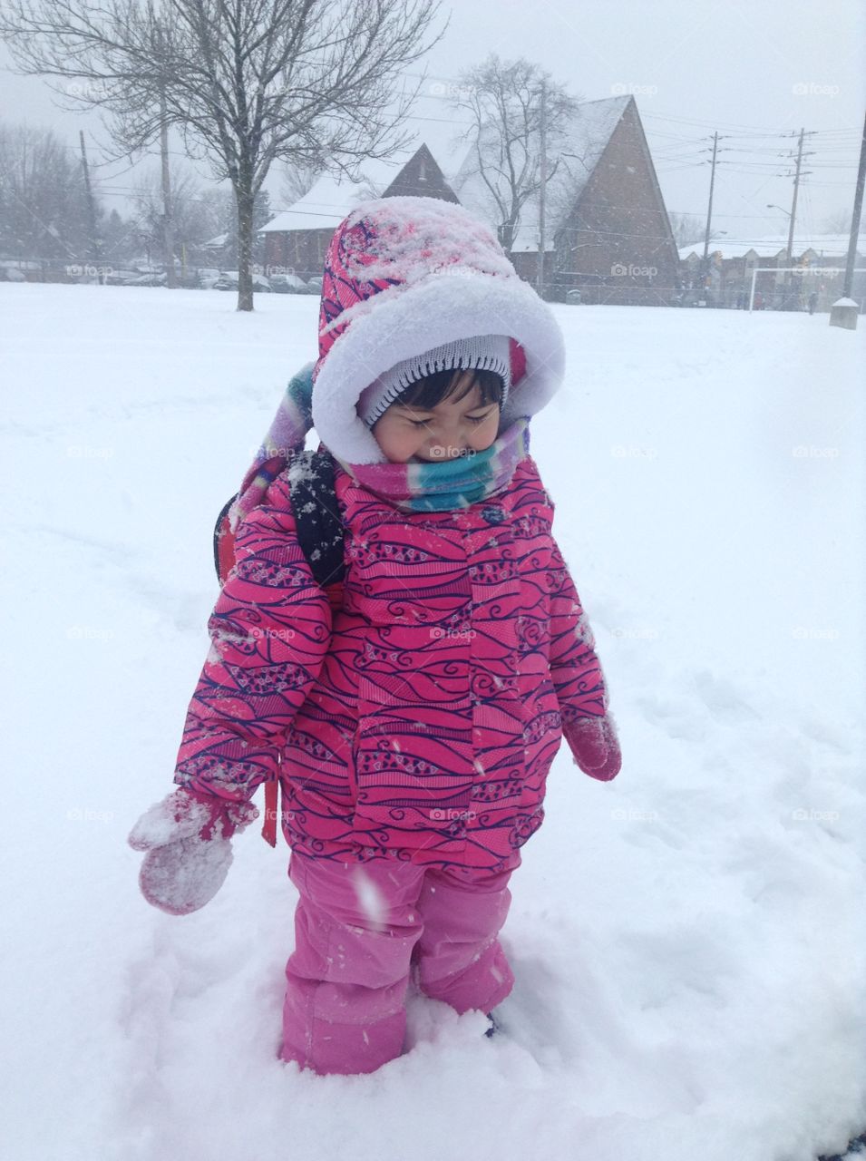 Small girl standing on snowy land