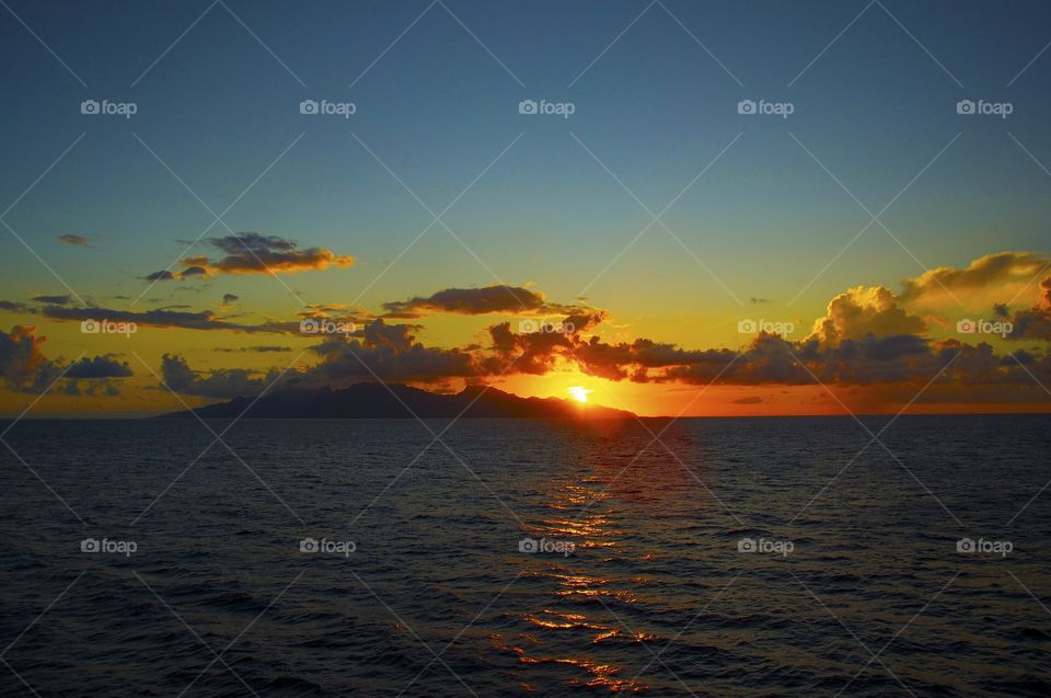 Sunset off the Pacific coast of Tahiti.