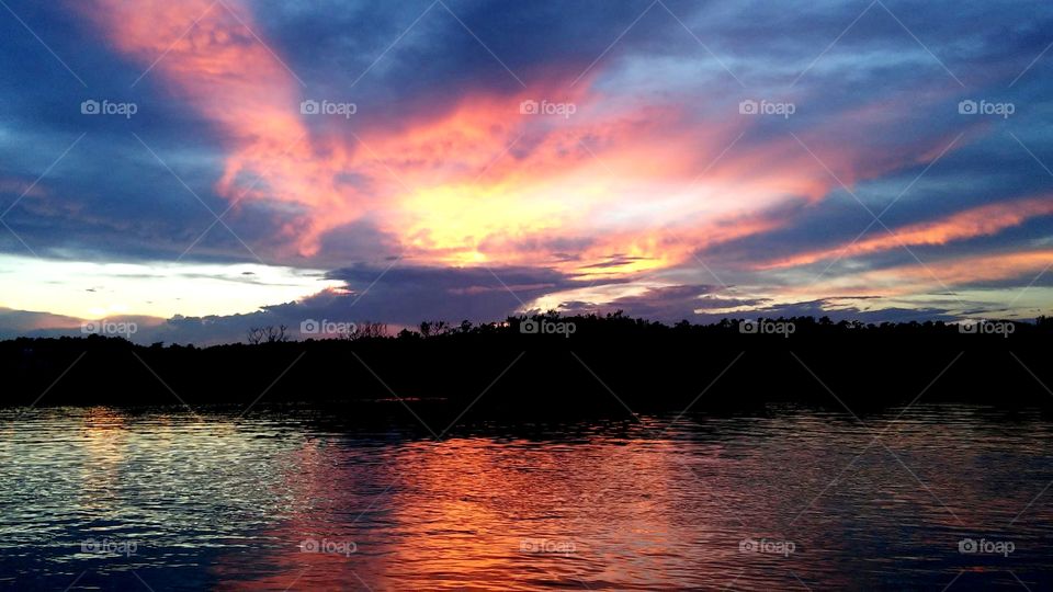 glorious mother nature orange and yellow glow clouds look like pegasus on fire sunsets over the salt marsh