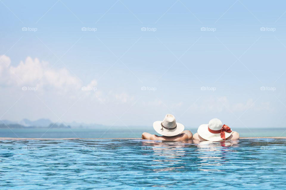 Rear view of couples in swimming pool