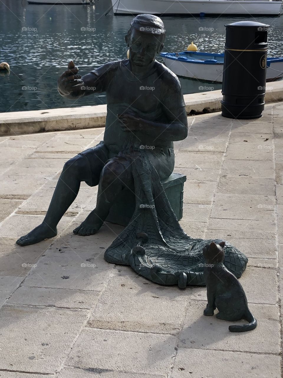 Fisherman feeding a cat, beautiful statue in Sliema, Malta 