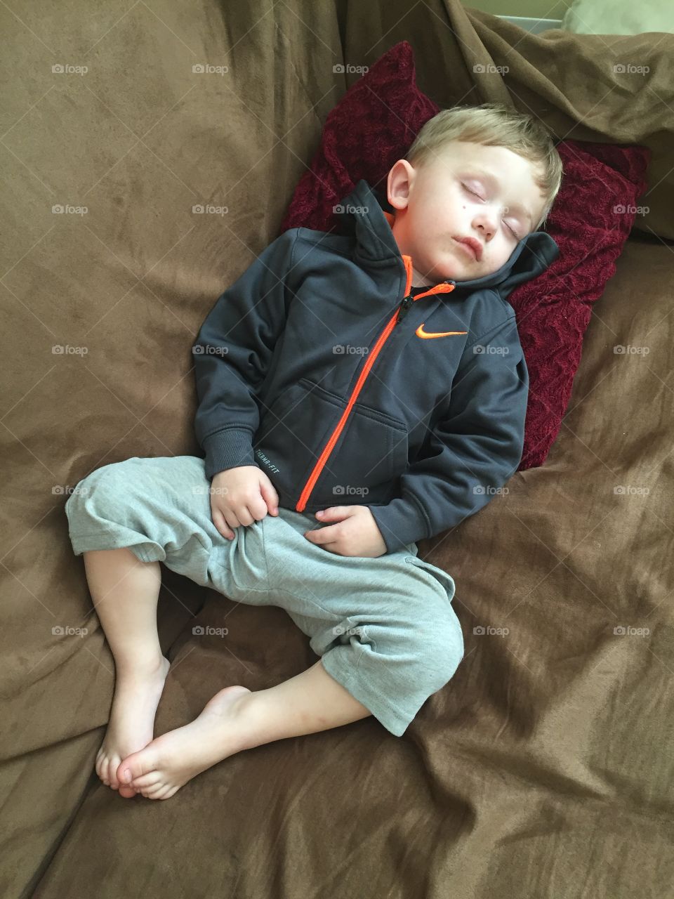 Boy resting on sofa