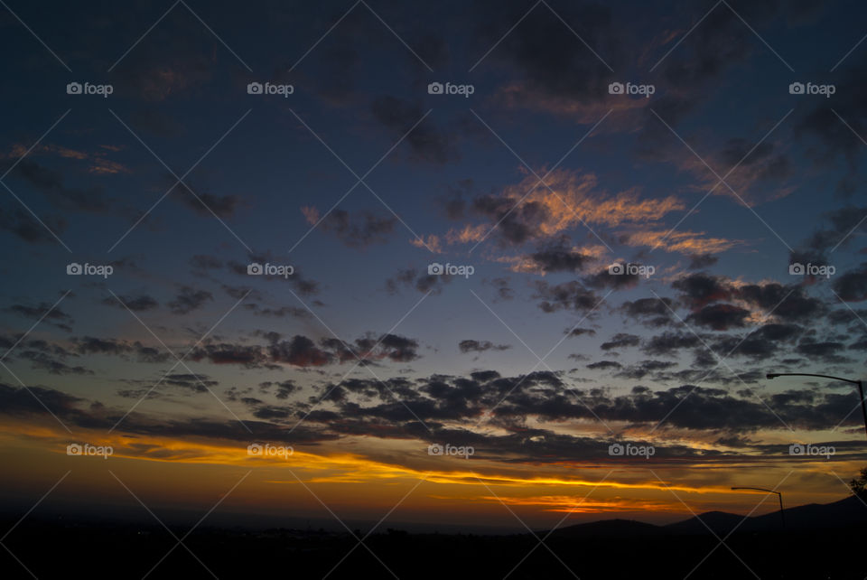 sunset with some clouds and blue sky