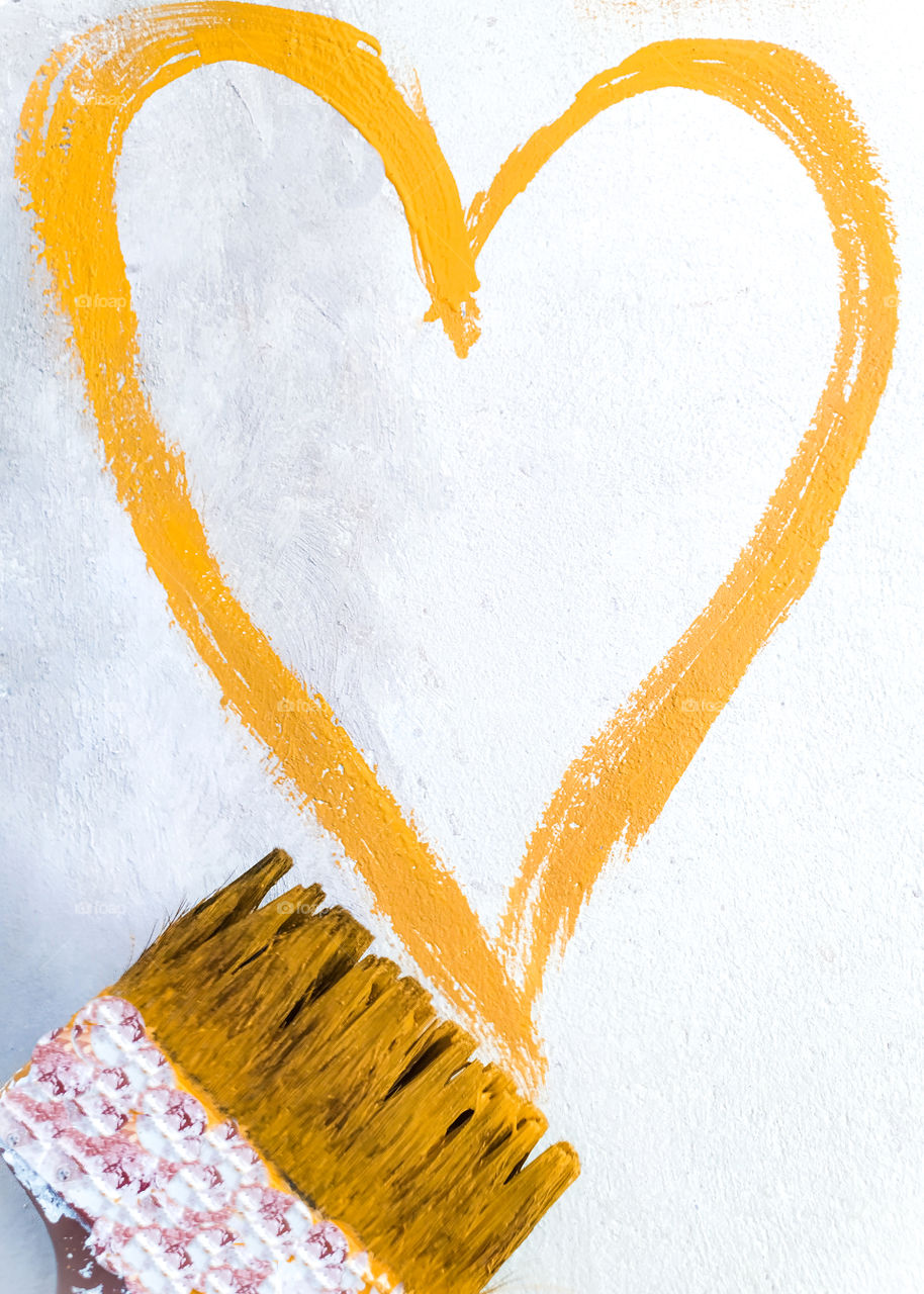 Mustard heart painted on the wall with a brush