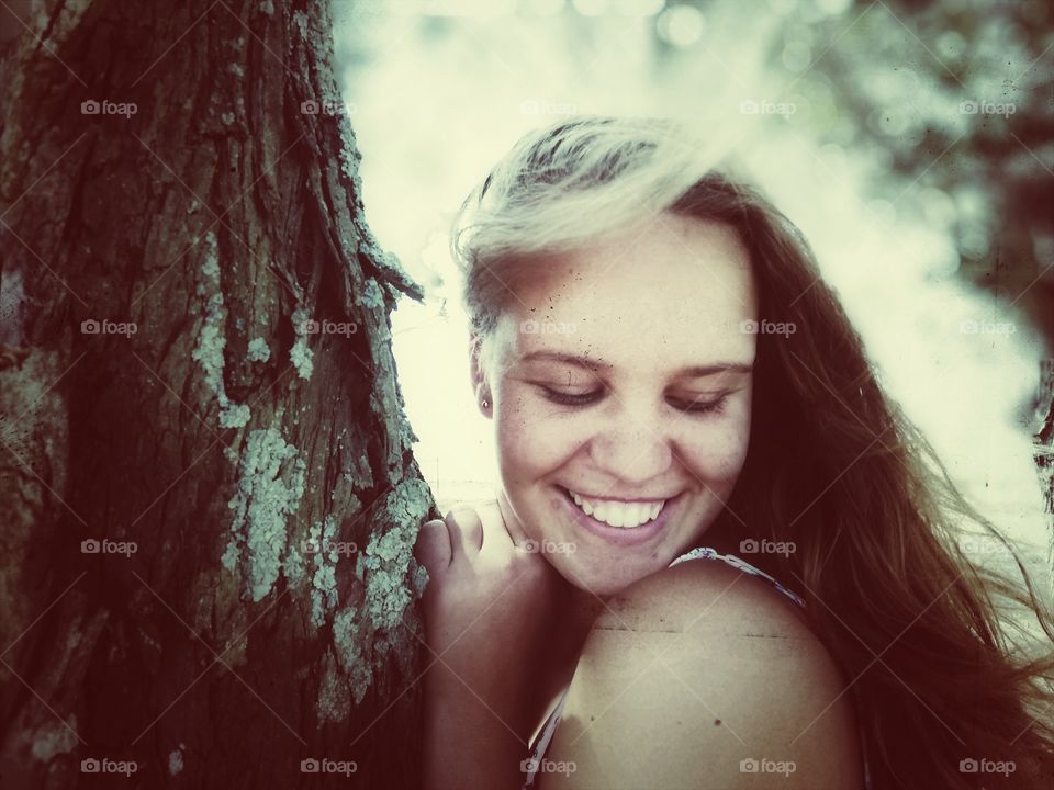 smiling girl standing in the forest